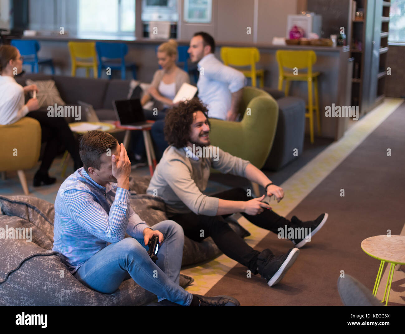 Work hard play hard. Workers Playing computer games in creative startup ...