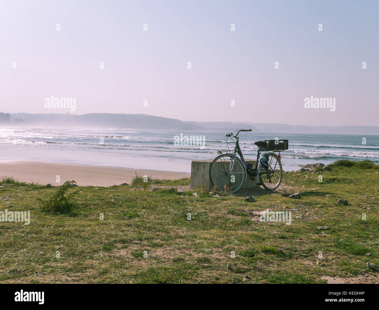 Bicycle is standing on the ocean beach. Toned photo. Stock Photo