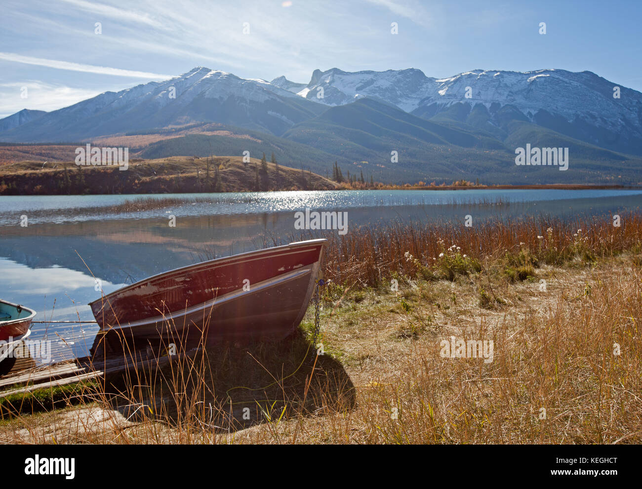 a red boat at the shoreline of Talbot Lake in Jasper National Park, Alberta Stock Photo