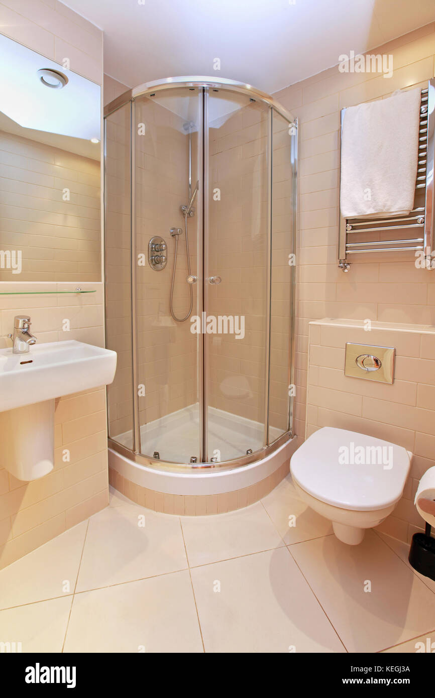 Small bathroom interior with modern shower in corner Stock Photo Alamy