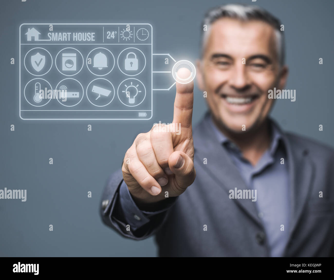 Confident man monitoring his smart house using a virtual touch screen