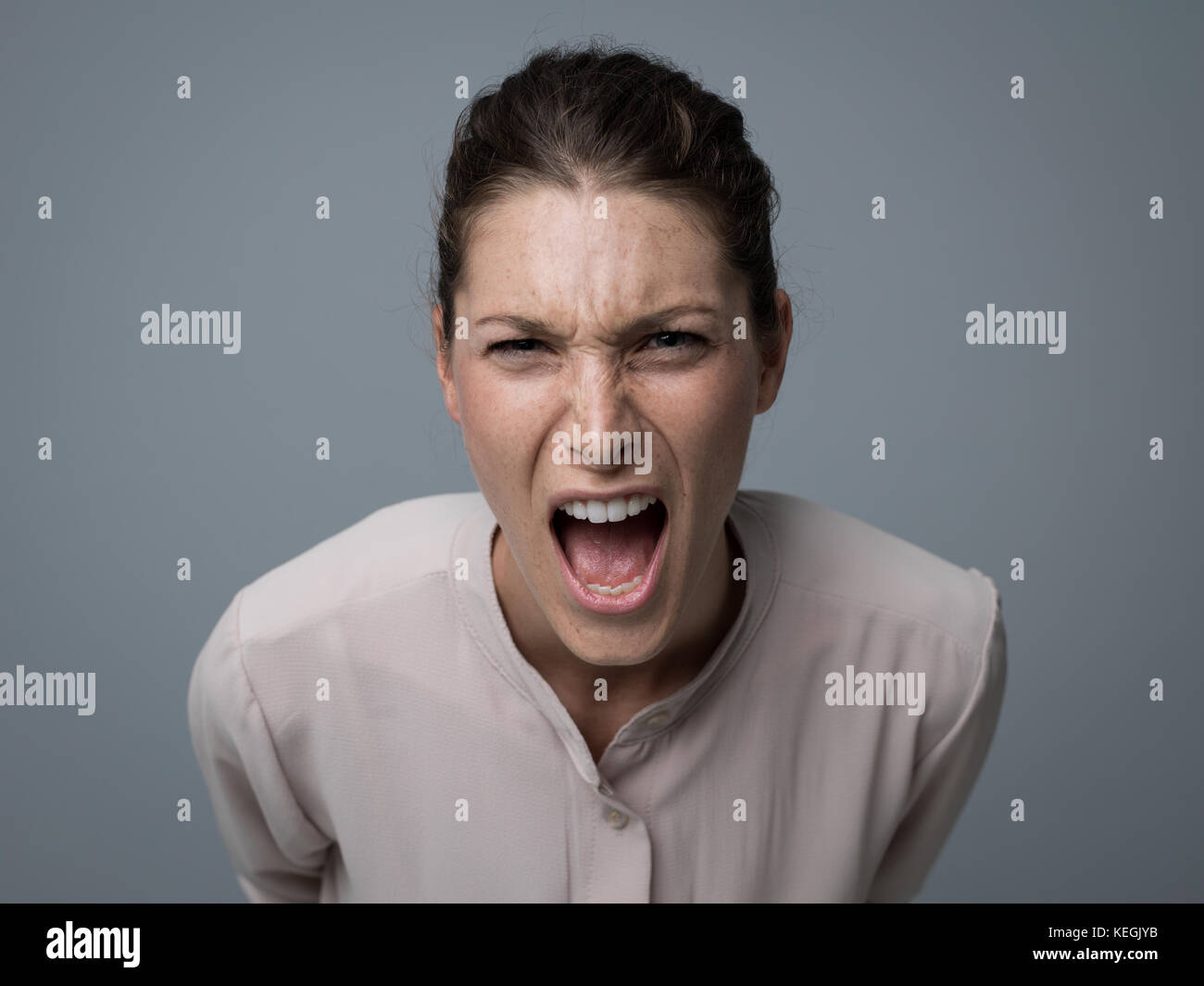 Aggressive angry woman yelling at camera, stress and negative feelings concept Stock Photo