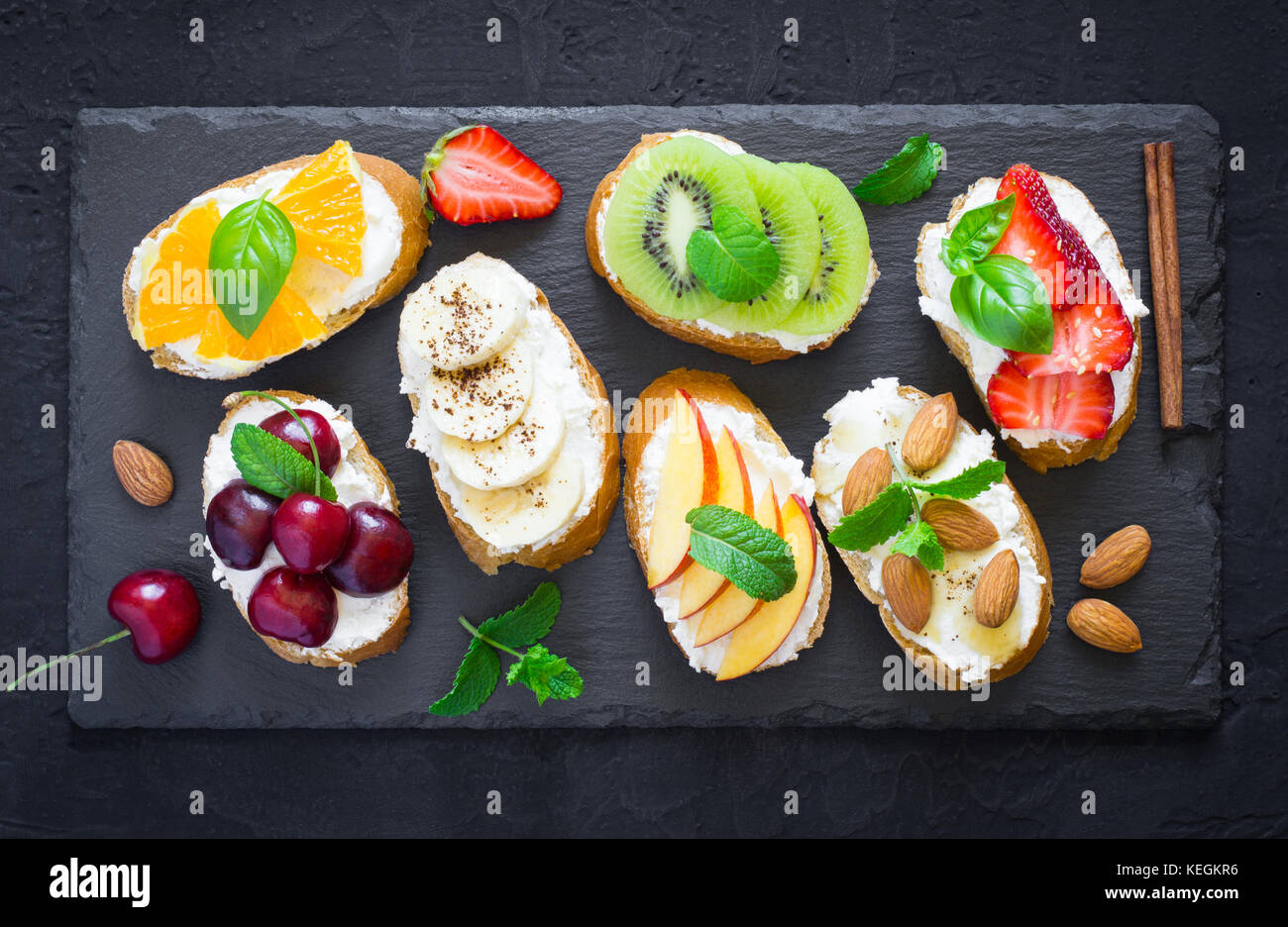 Assorted summer sweet snacks. Bruschetta or sandwiches with fruit and