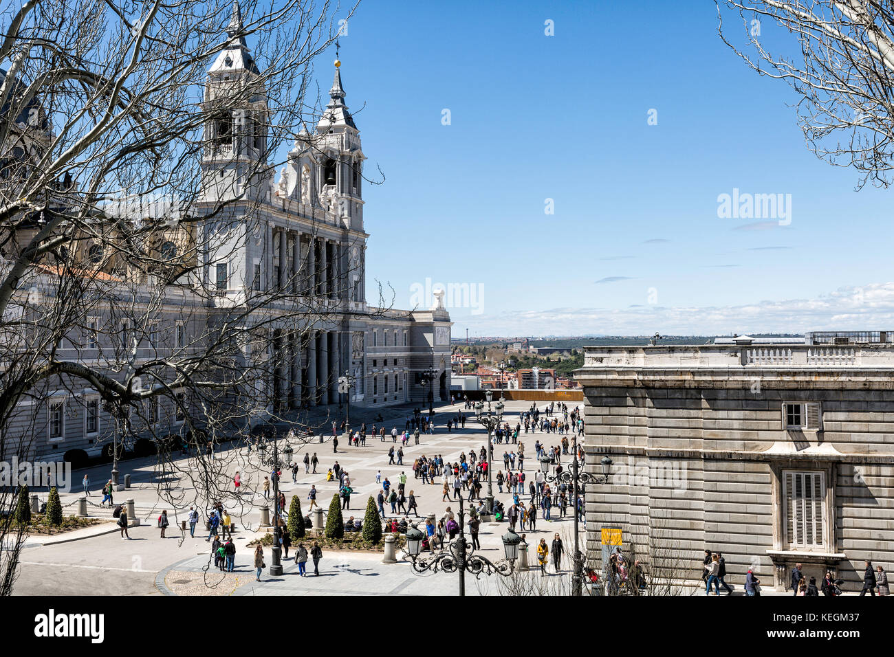 Madrid, SPAIN - april 09, 2016: visitors walking in Almudena square between  Almudena Cathedral  and Royal Palace, on April 09, 2016 in Madrid, Spain Stock Photo