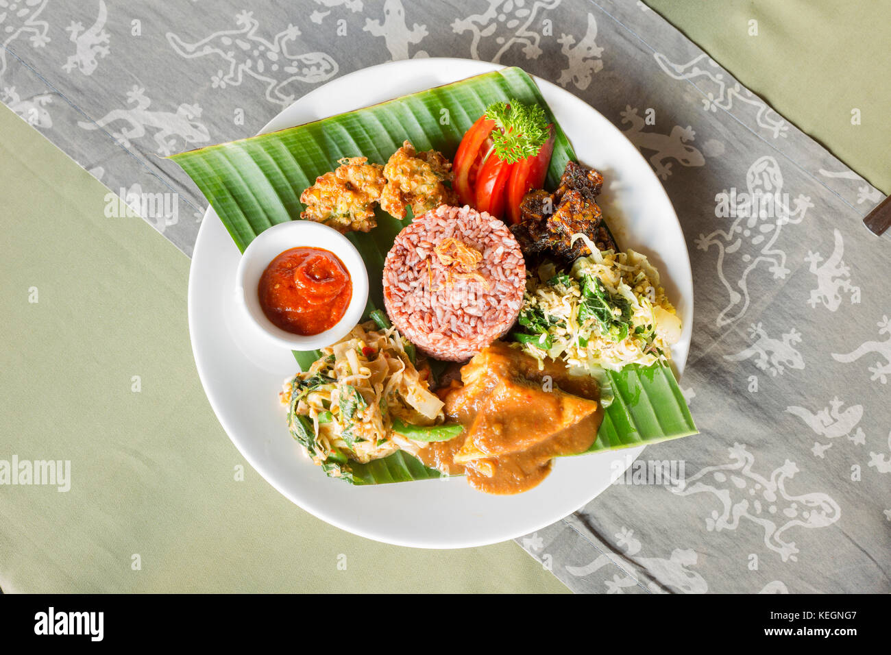 Balinese Nasi Campur, consisting of sweet tempe, tofu, mixed green vegetables, corn fritters, sambal and rice, Bali, Indonesia Stock Photo