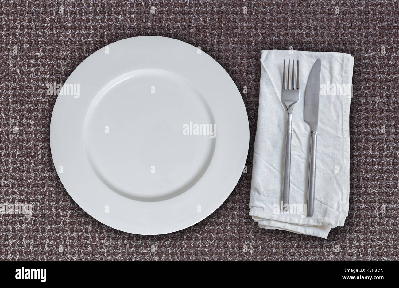 Empty plate and cutlery on multiplex plate. Stock Photo