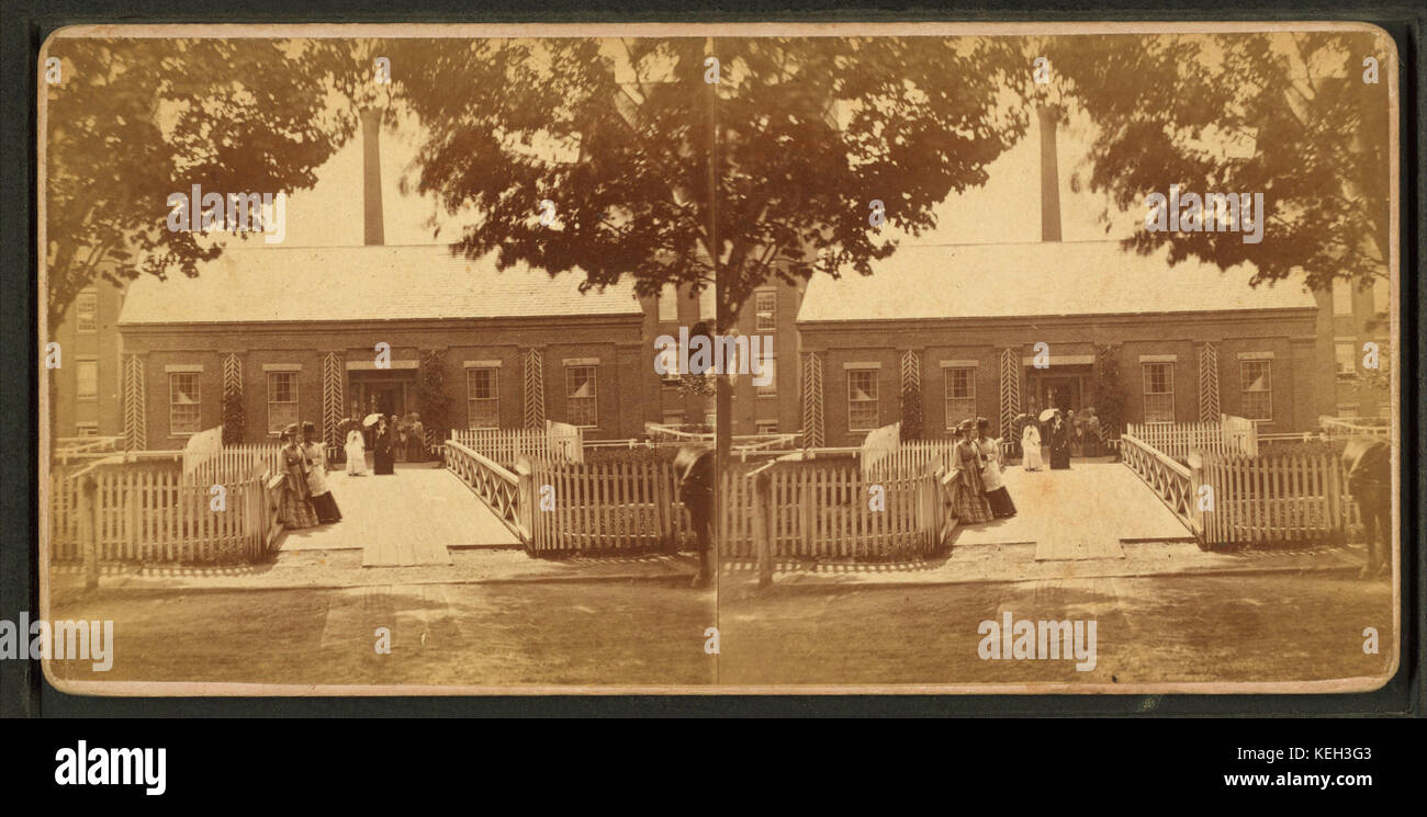 Ladies standing at the front of a building, by Conant Bros Stock Photo