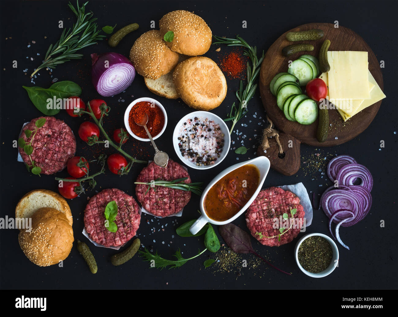 Ingredients for cooking burgers. Raw ground beef meat cutlets, buns