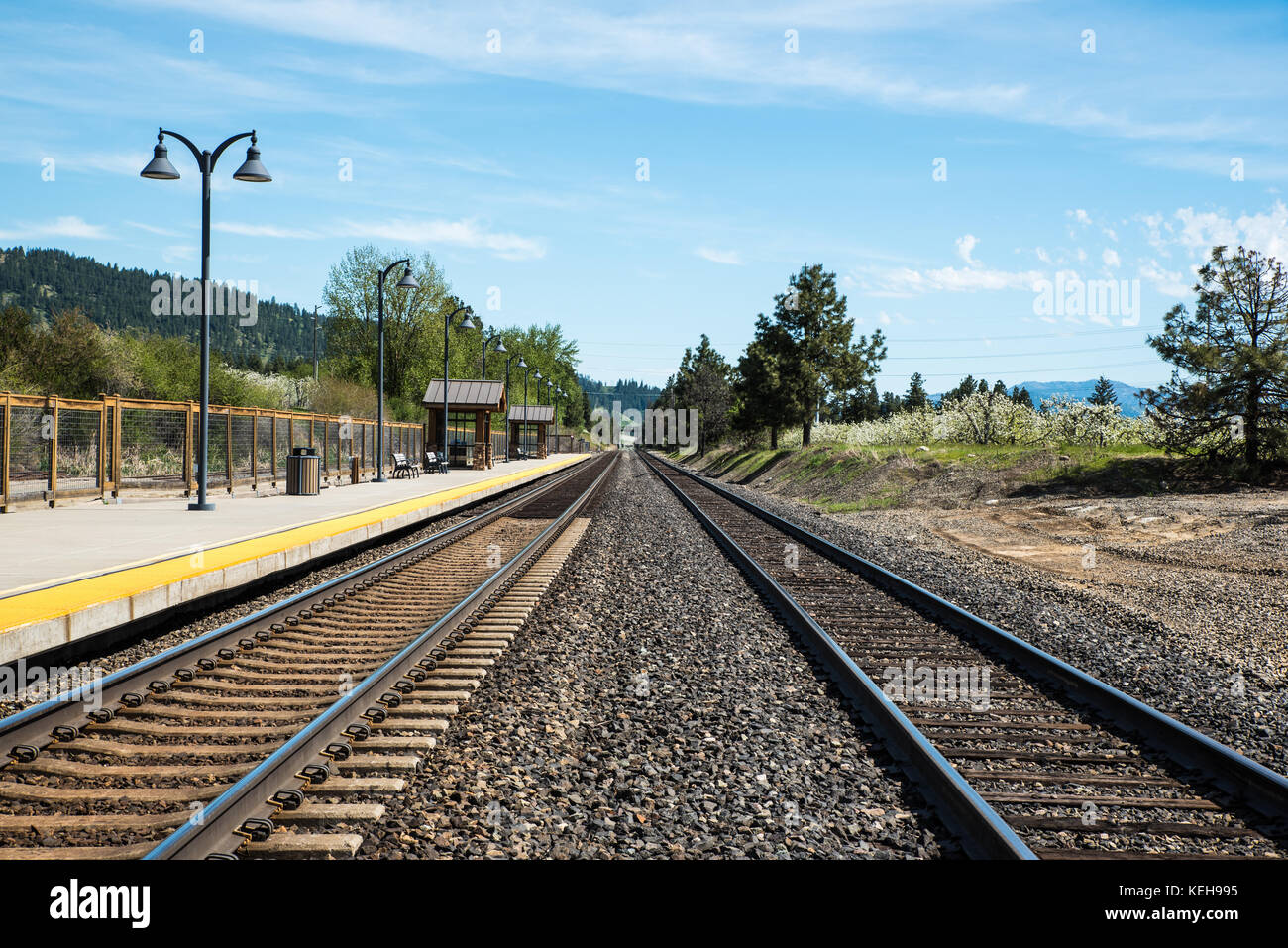 Wenatchee Bound - The Icicle Station serves train travelers at Leavenworth. These tracks lead to Wenatchee and the Columbia River. Stock Photo