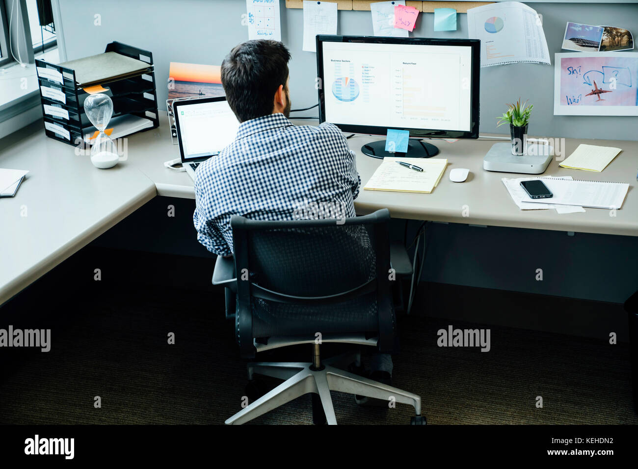 Caucasian businessman using laptop and computer in office Stock Photo