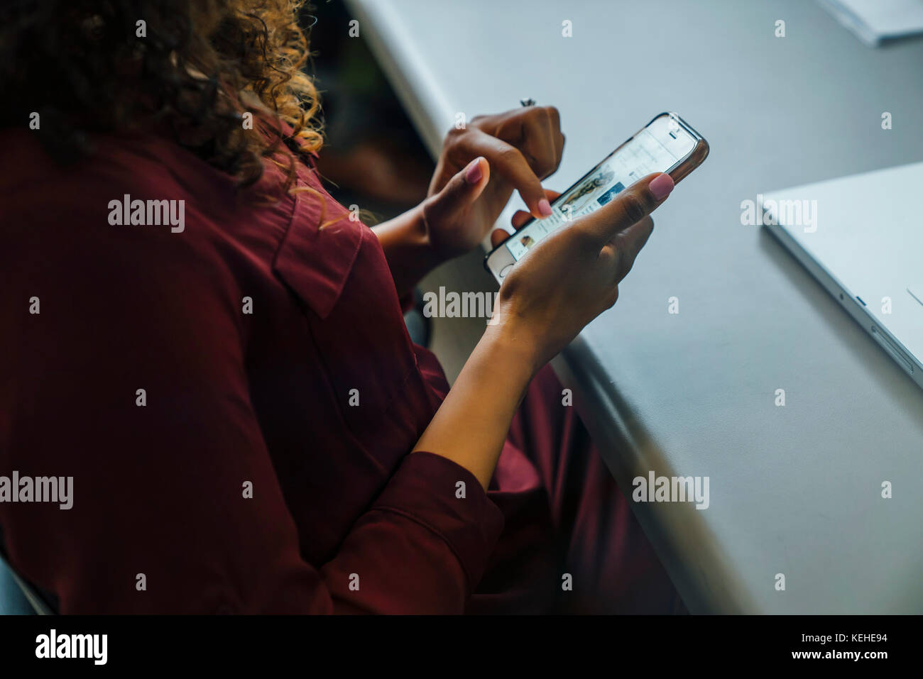 Mixed race businesswoman using cell phone Stock Photo