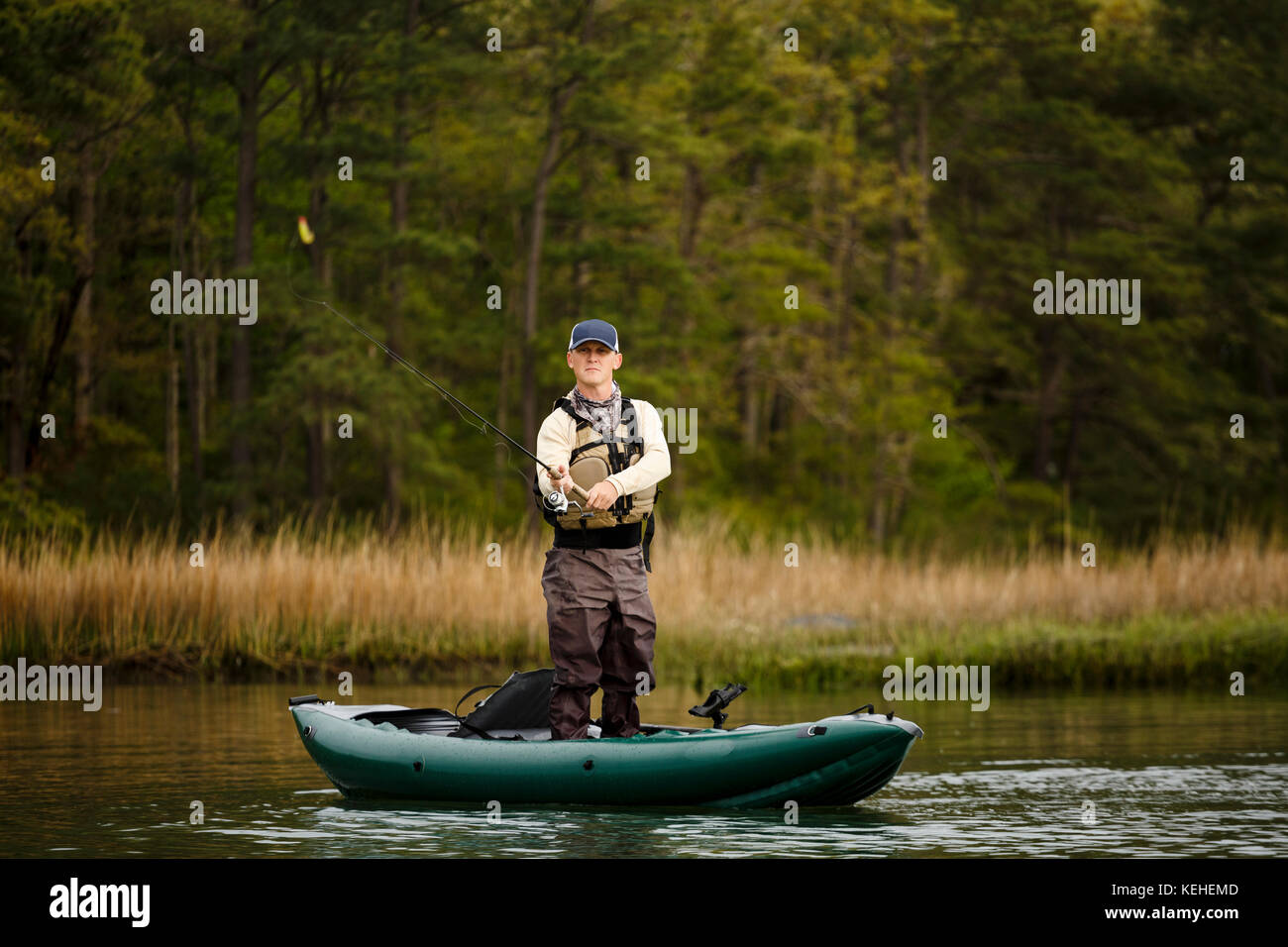 Caucasian man fishing on kayak Stock Photo