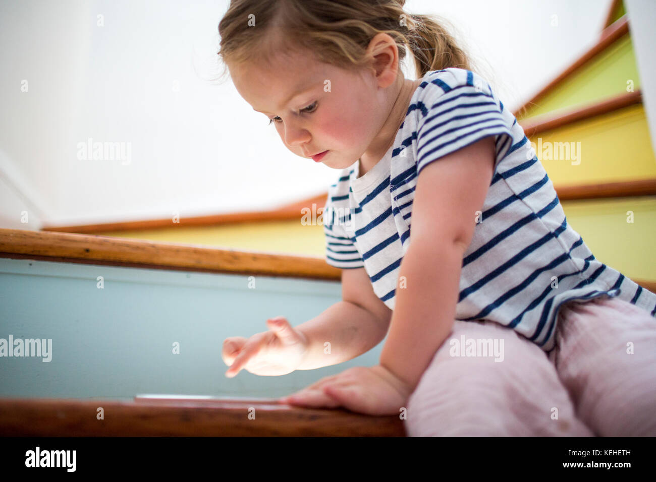 Caucasian girl using digital tablet on staircase Stock Photo