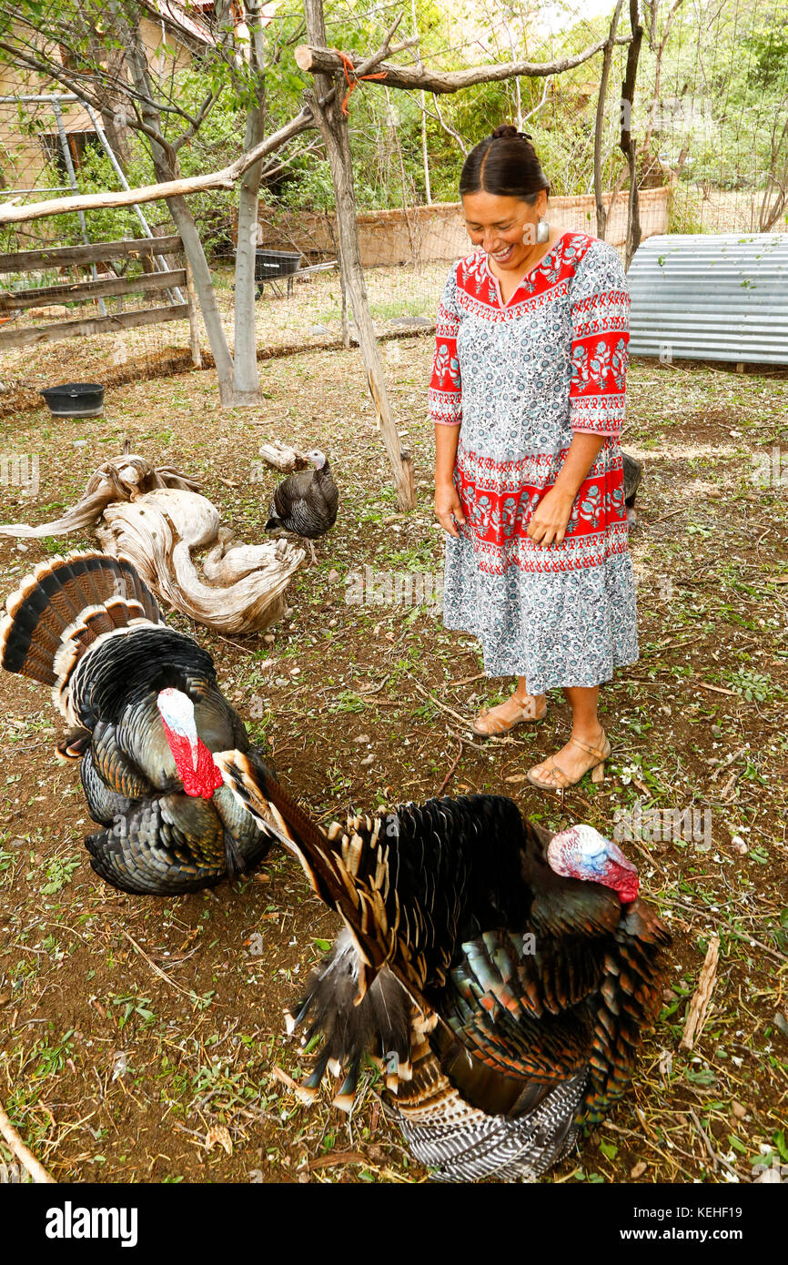Mixed race woman watching turkeys and laughing Stock Photo