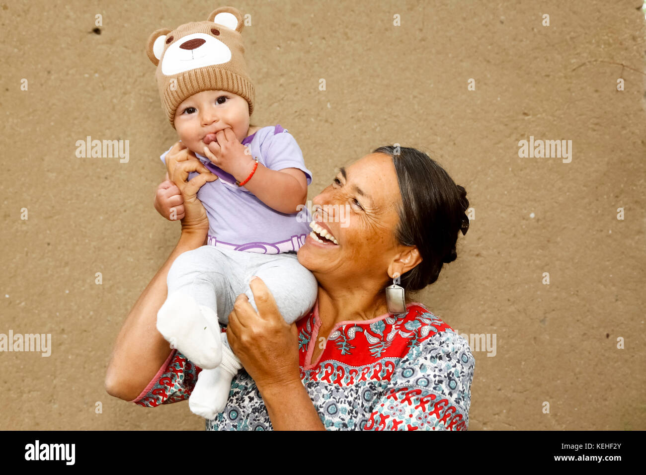 Mother carrying baby son on shoulder Stock Photo