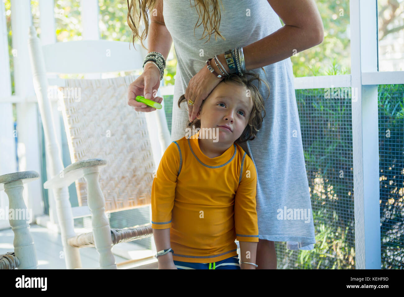 Caucasian mother applying sunscreen to face of son Stock Photo