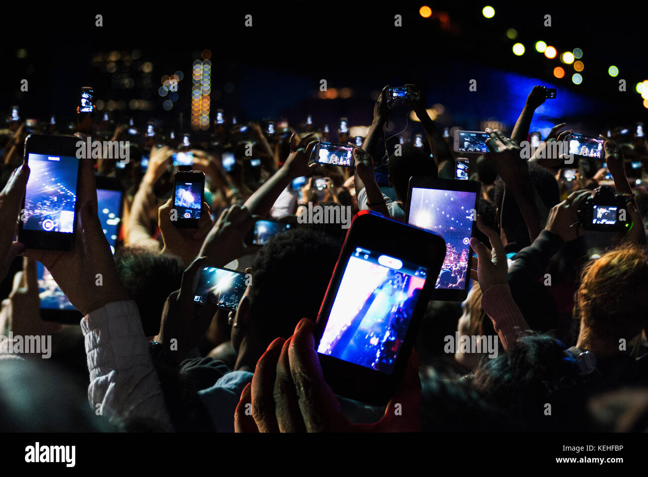 Crowd of people recording video with cell phones at night Stock Photo