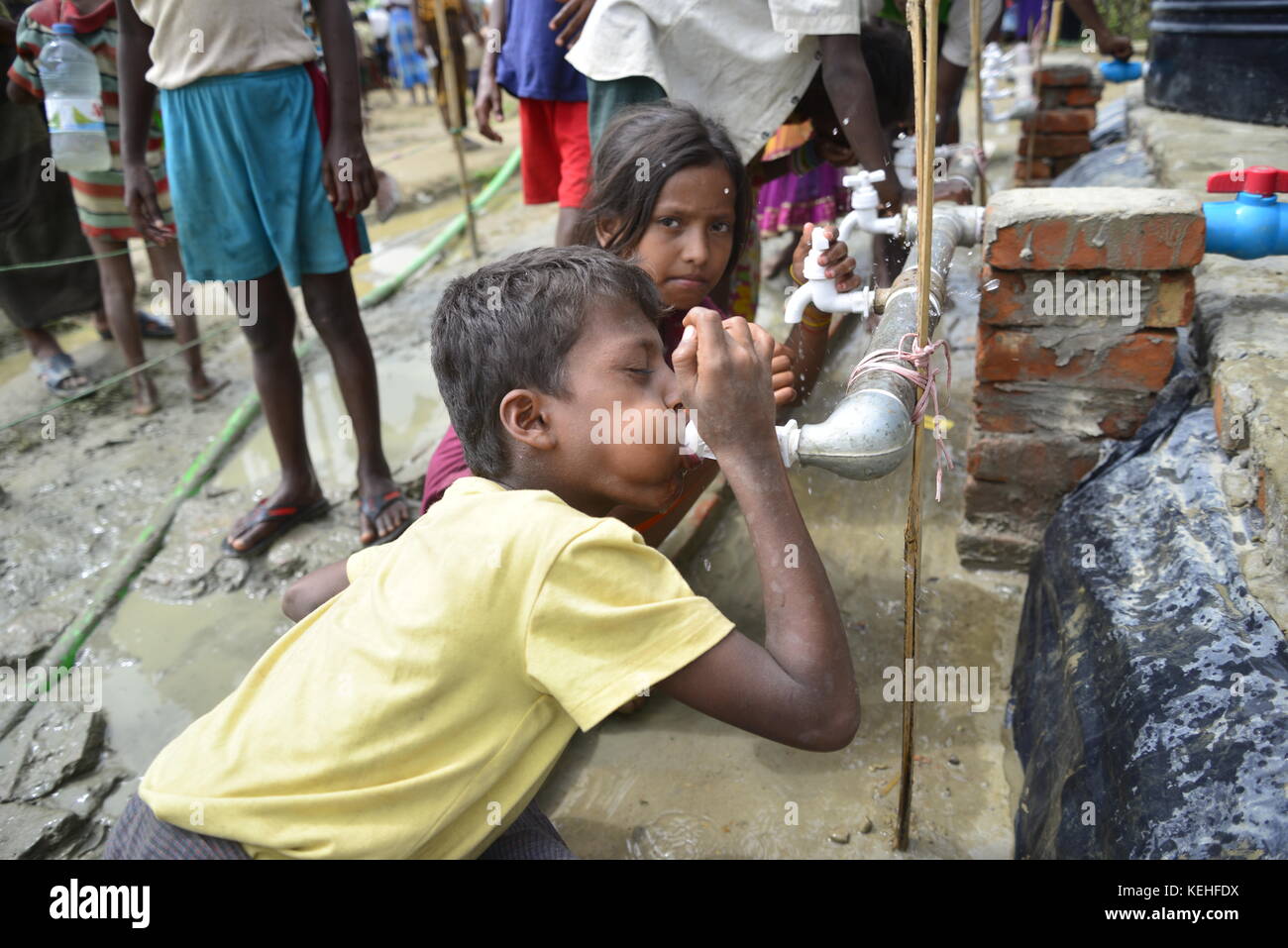 A Rohingya children drinking water from the water tank at the ...