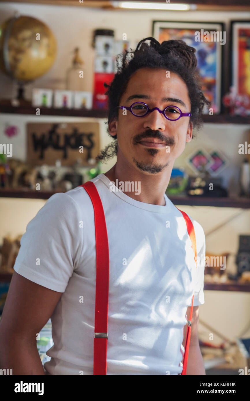 Serious mixed race man wearing suspenders Stock Photo