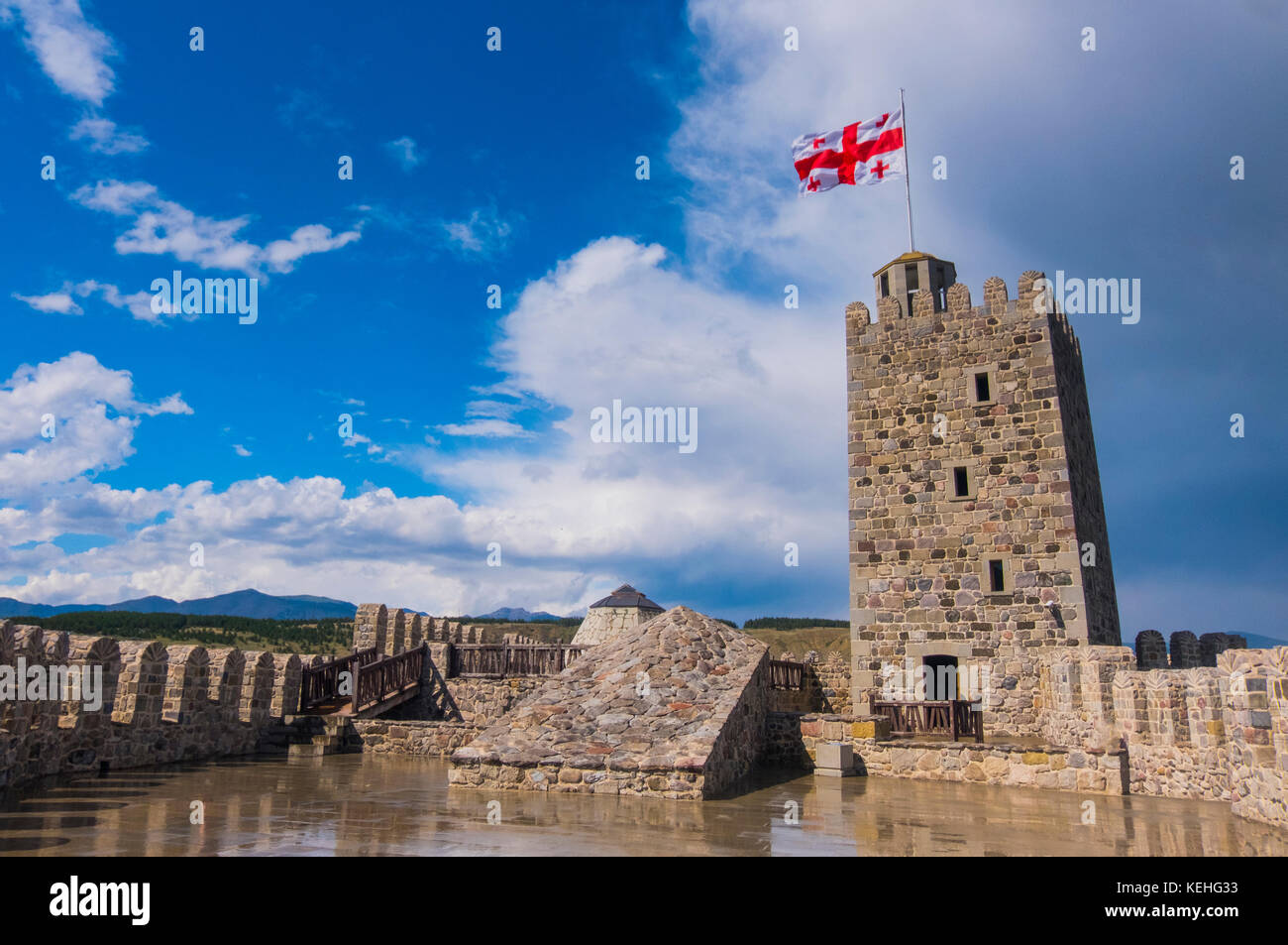 Flag blowing in wind on top of castle Stock Photo