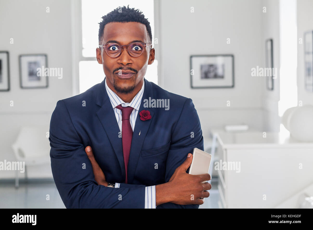 Black man with arms crossed in gallery Stock Photo - Alamy