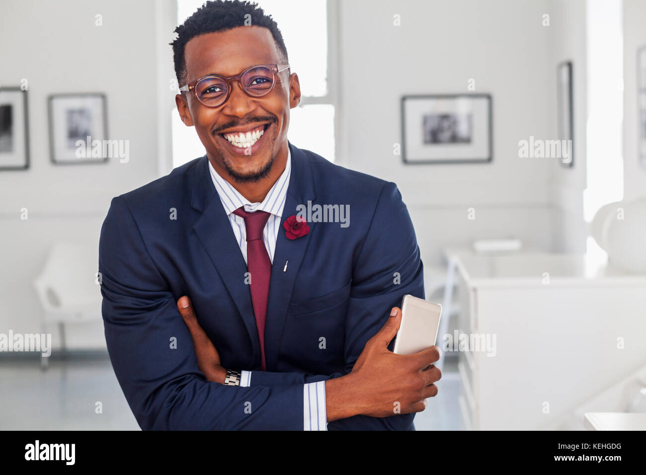 Black man with arms crossed in gallery Stock Photo - Alamy
