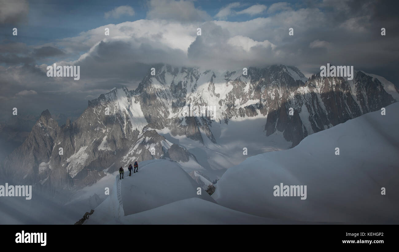 Caucasian men hiking on mountain in winter Stock Photo - Alamy