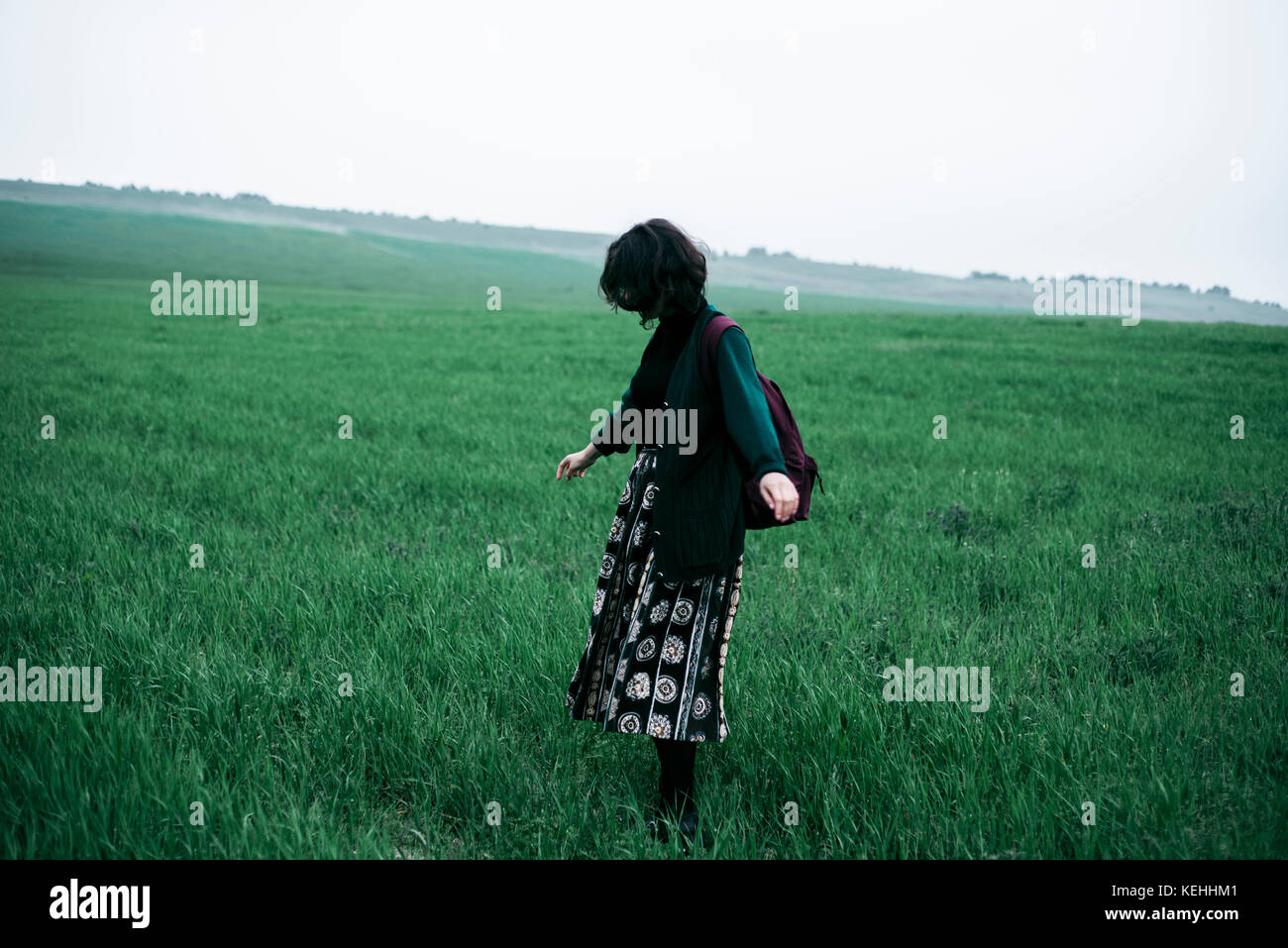 Caucasian woman standing in field of grass Stock Photo