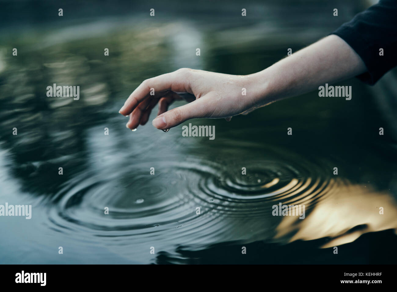 Water dripping from hand of woman Stock Photo Alamy