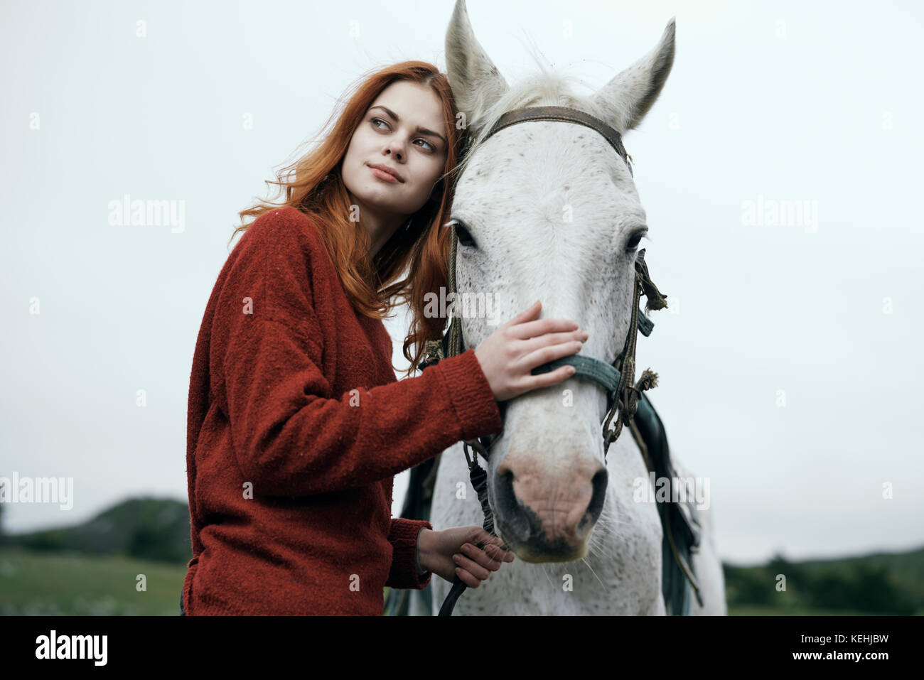 Caucasian woman petting horse Stock Photo