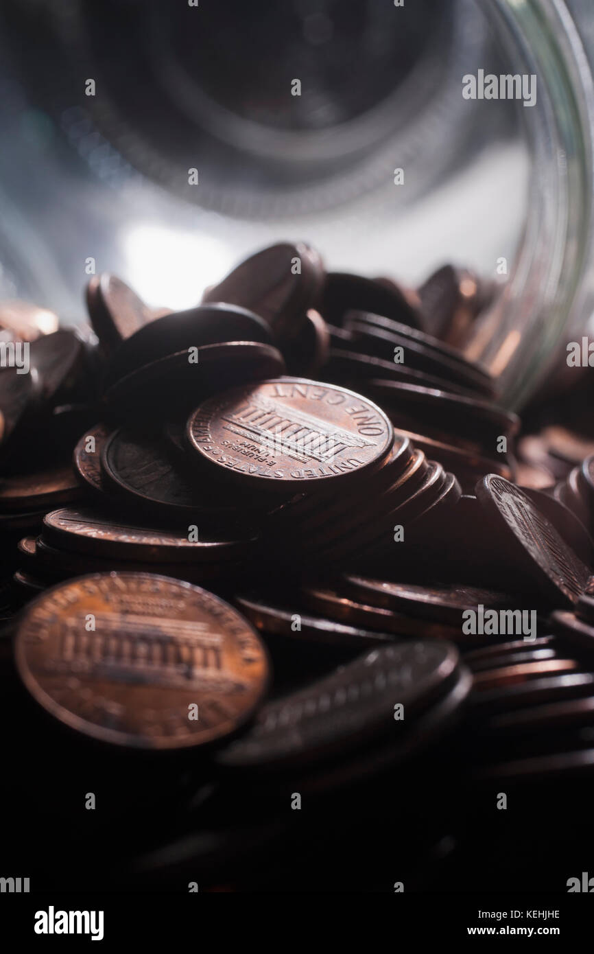 Pile of pennies near jar Stock Photo