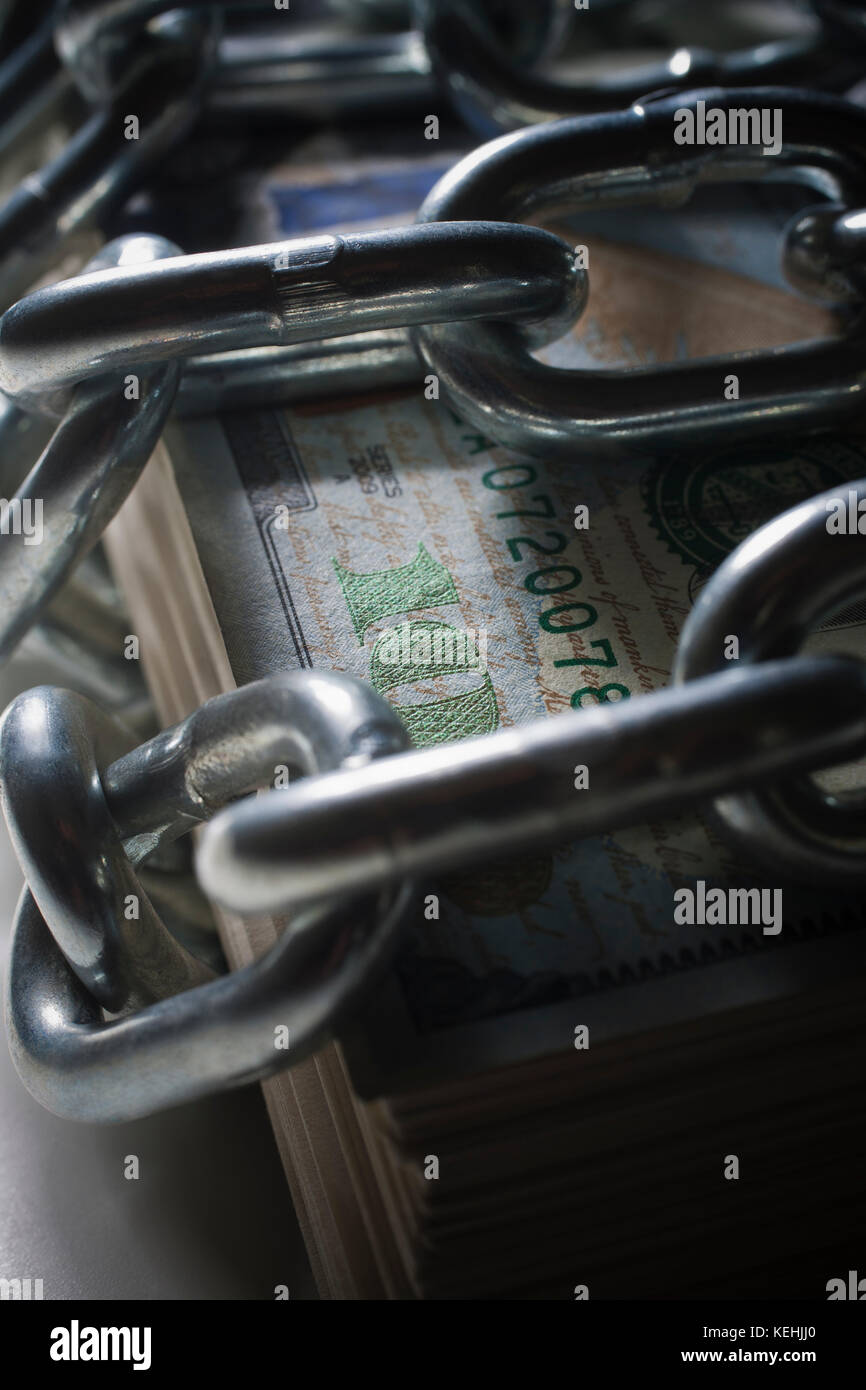 Chains on stack of money Stock Photo