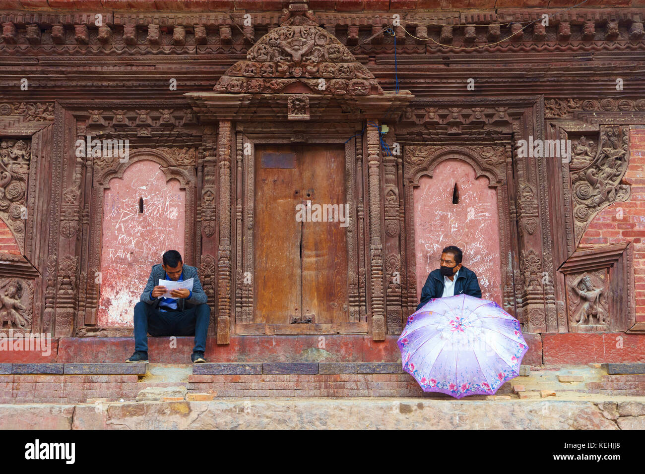 Two men resting at Jagannath temple, Durbar square, Kathmandu. Stock Photo