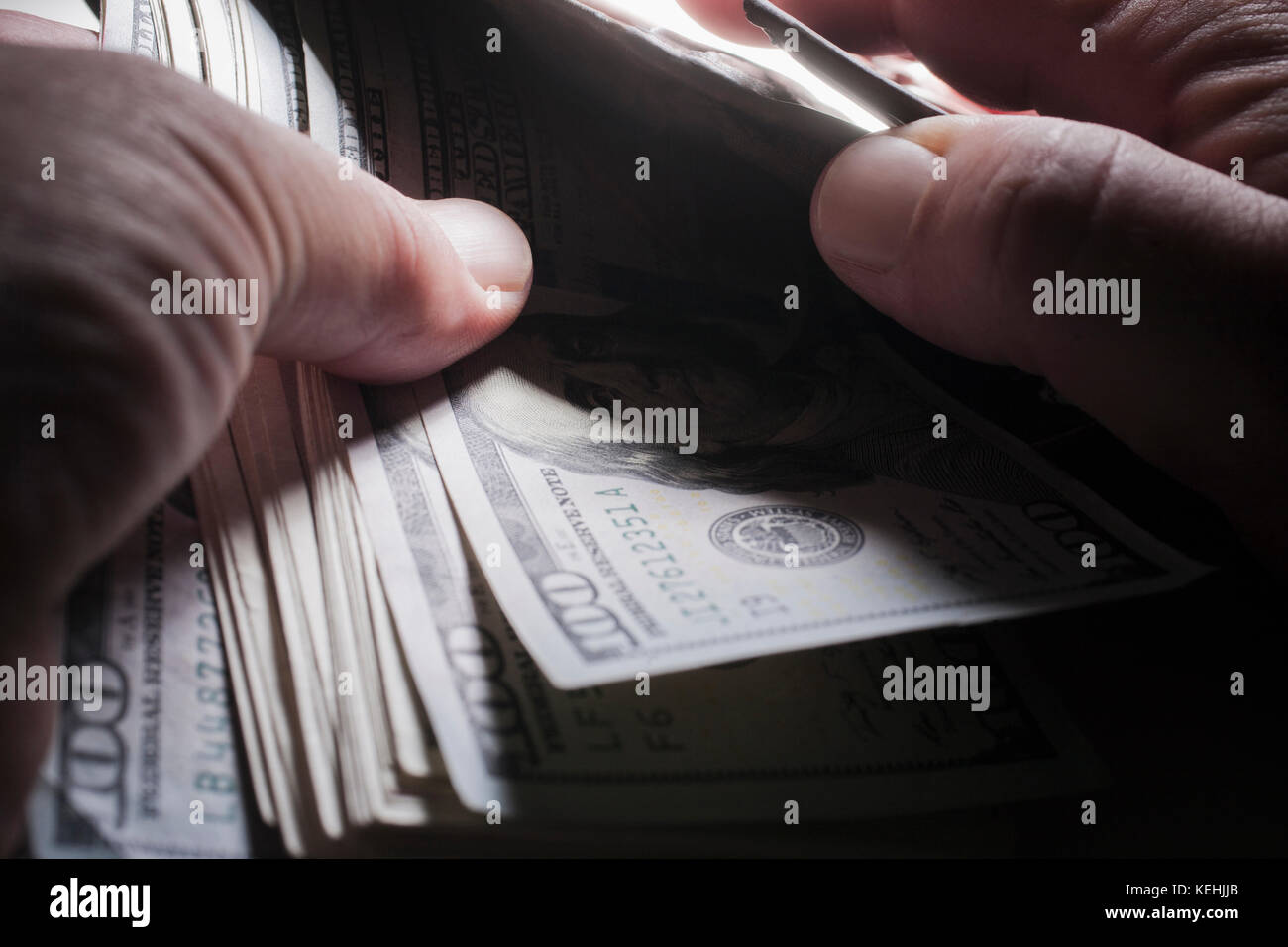 Hands of man counting money Stock Photo