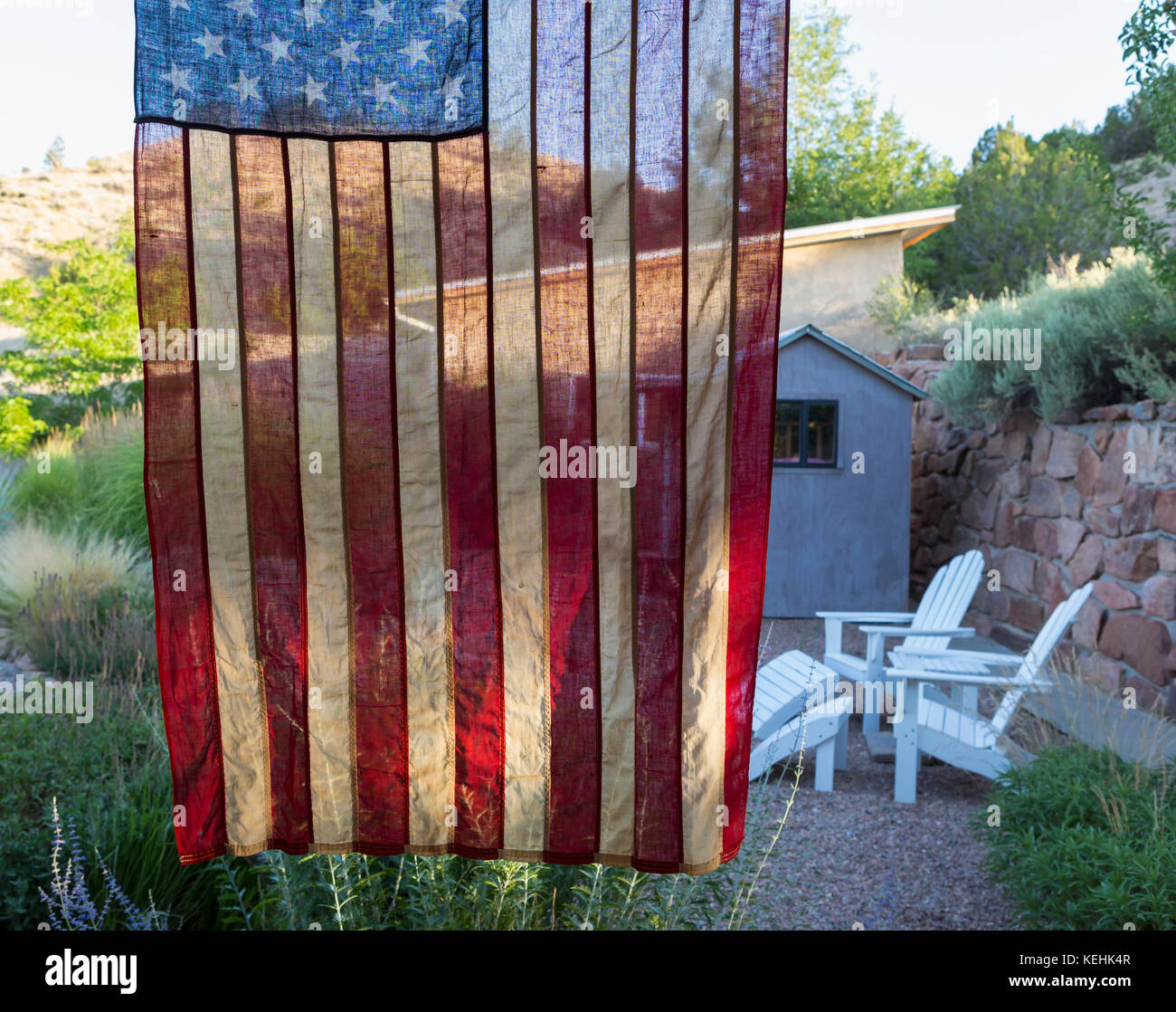 American flag hanging near house Stock Photo