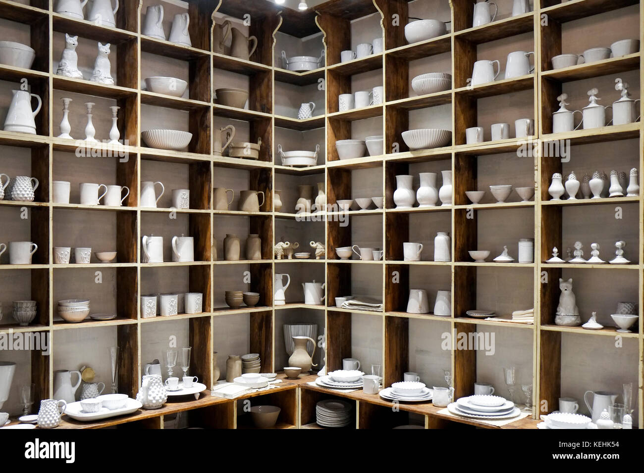 White ceramic pottery on shelves in store Stock Photo