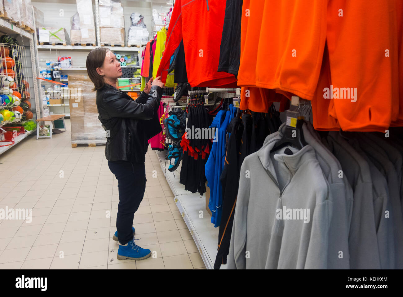 Caucasian woman examining shirt in store Stock Photo