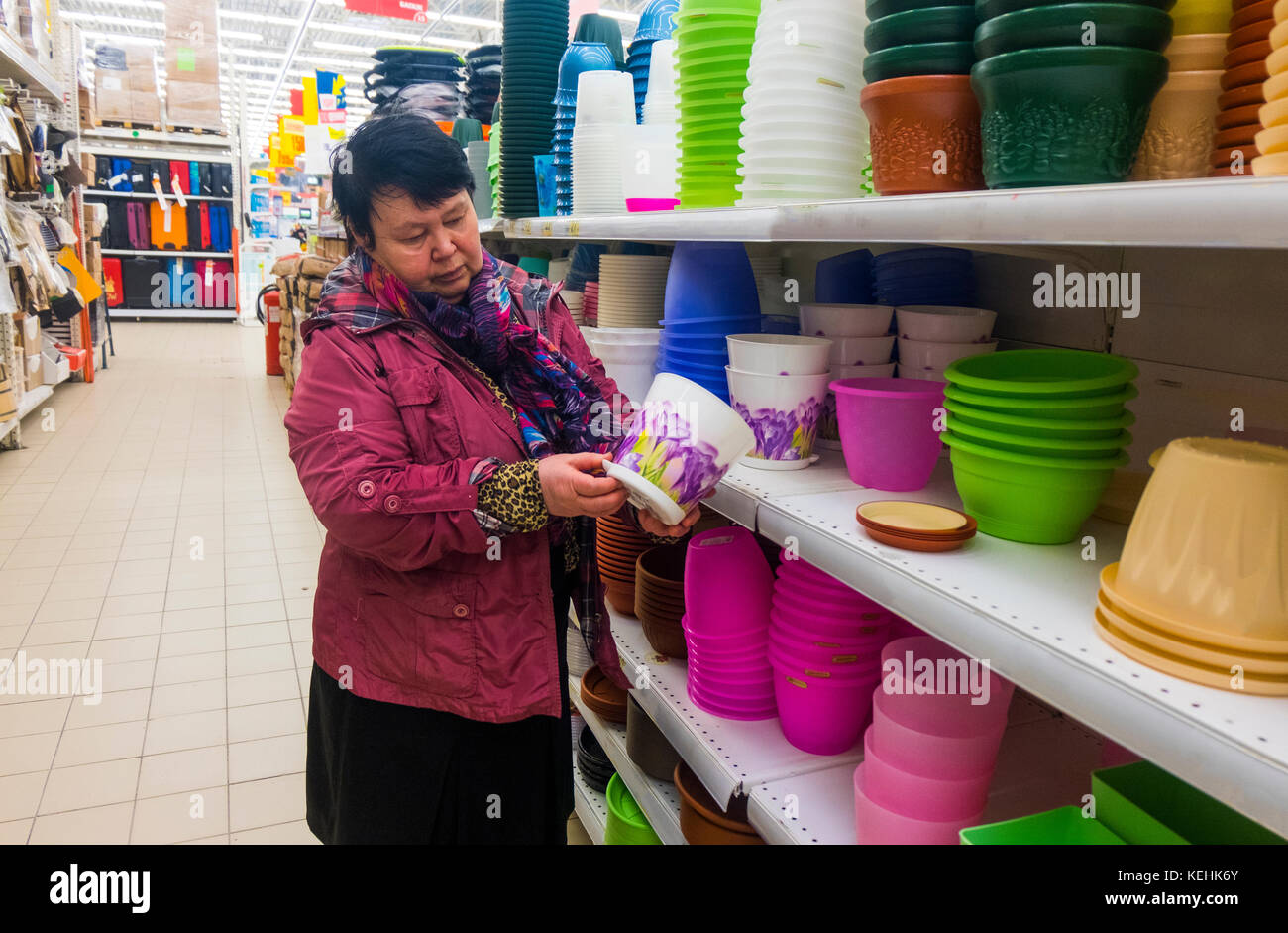 Caucasian woman examining pot in store Stock Photo