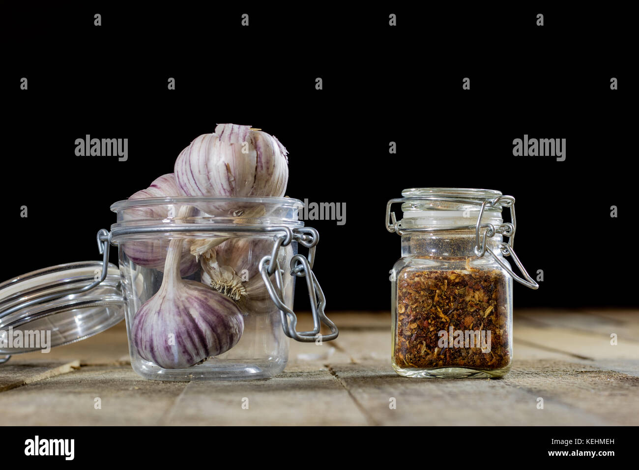 Tasty garlic on a wooden kitchen table. Vegetables in the kitchen ...