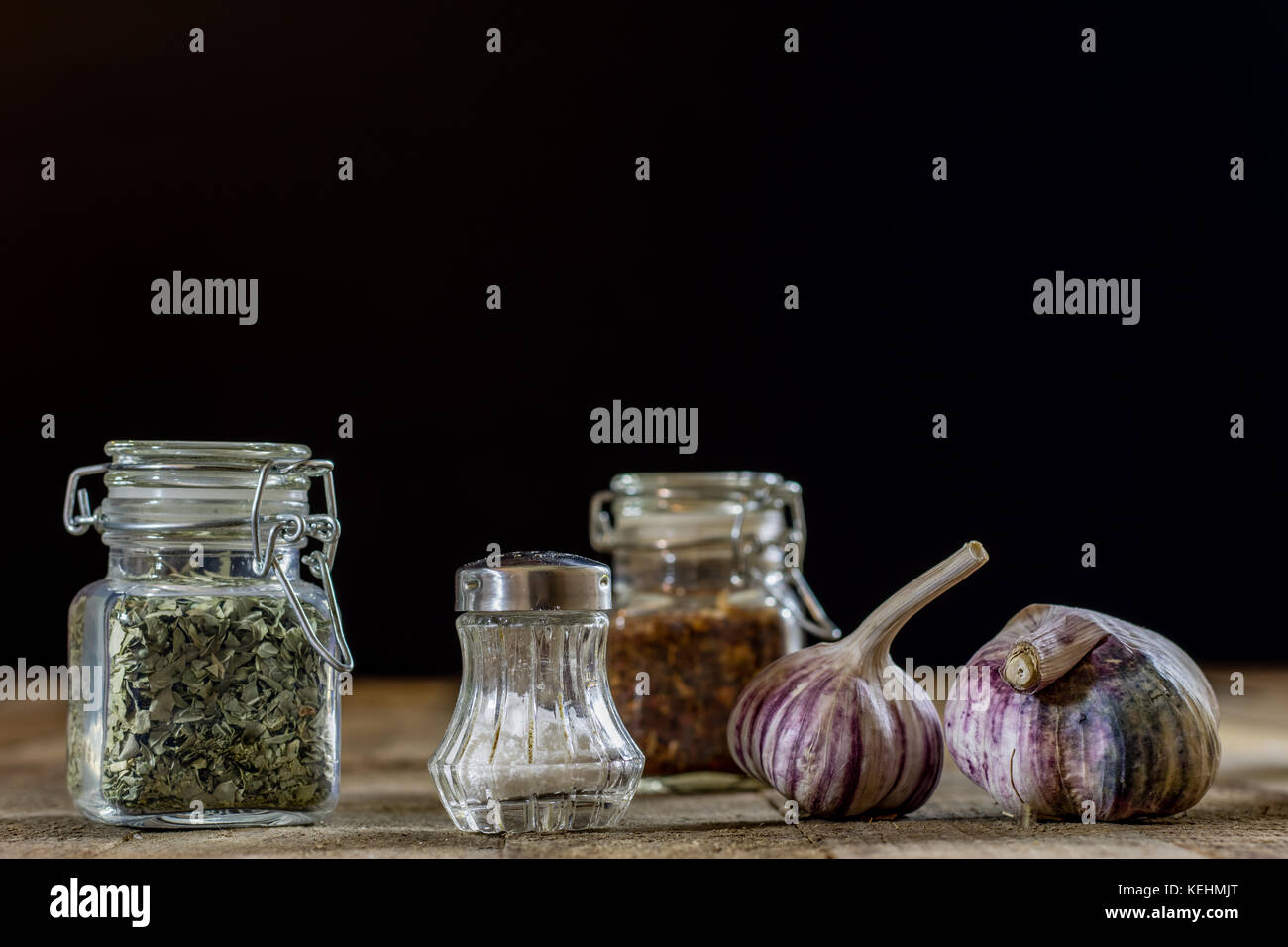 Tasty garlic on a wooden kitchen table. Vegetables in the kitchen ...