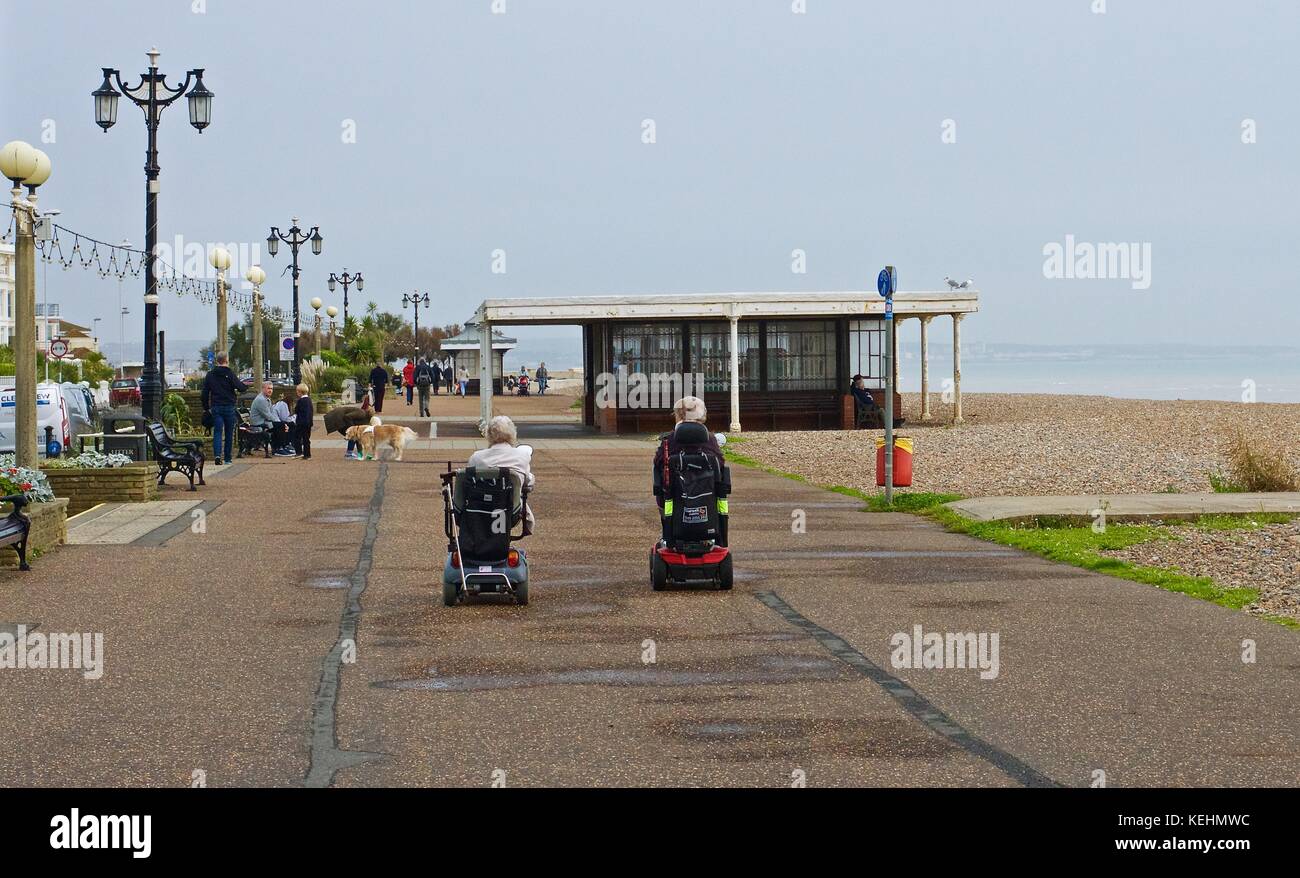 Two elderly ladies on mobility scooters on the promenade, Worthing, UK Stock Photo