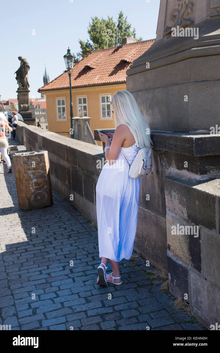 Czechia woman wearing white dress standing alone and waiting friends at