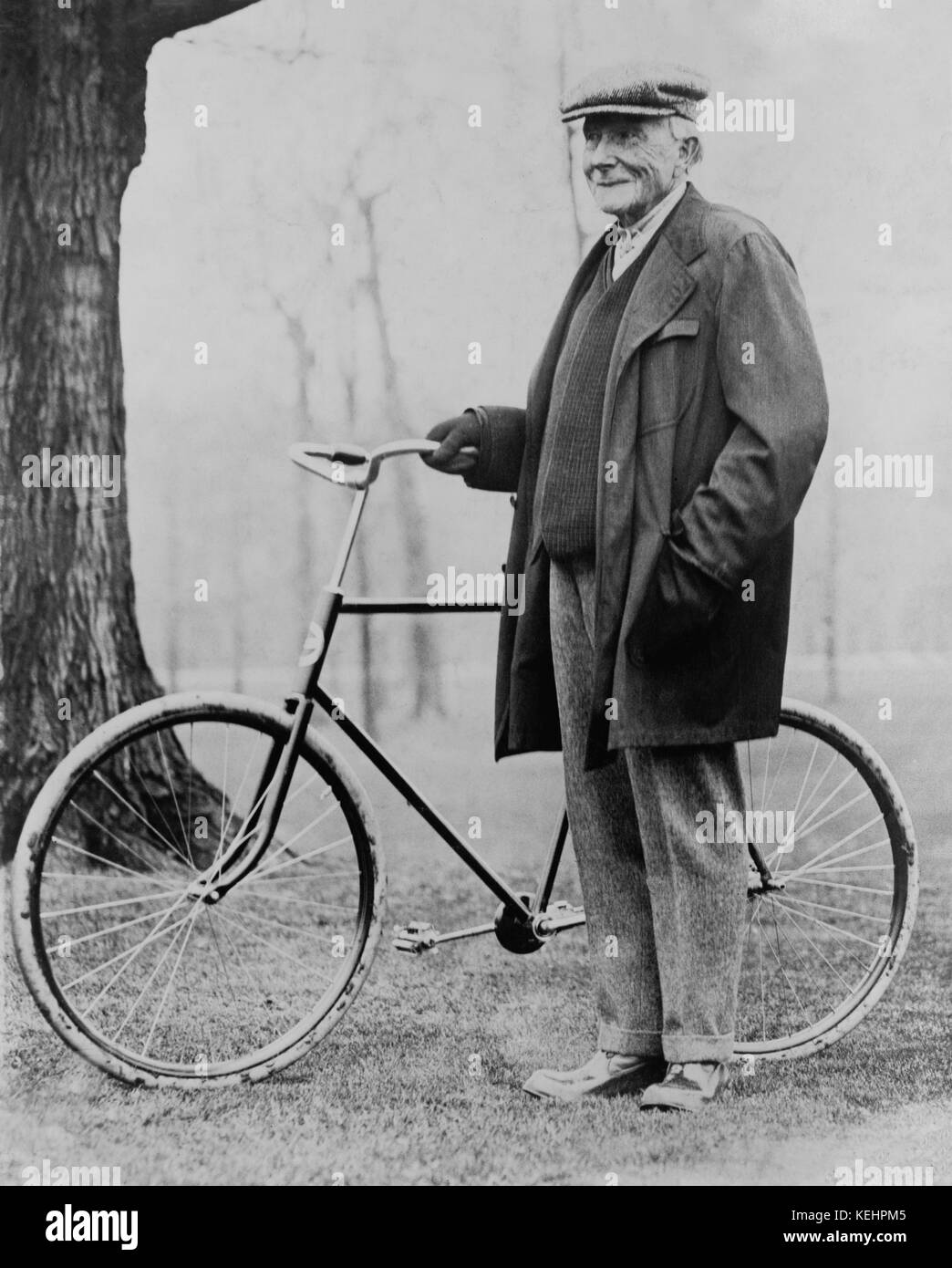 John D. Rockefeller (1839-1937),Portrait standing with Bicycle,1913 Stock Photo