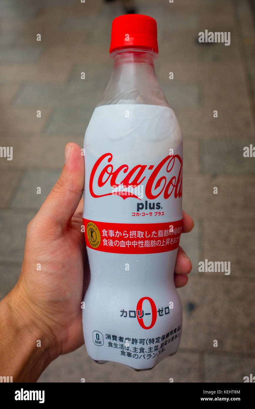 TOKYO, JAPAN -28 JUN 2017: Hand holding the new Coca Cola Plus, now  available in some vending machines in Japan. Throughout Japan, This new Coca  Cola Contains ingredients that nourish the body