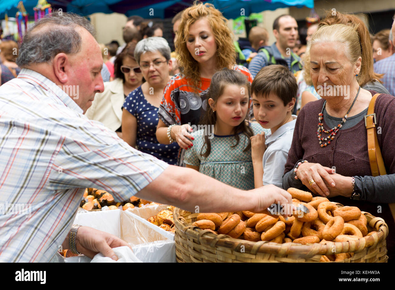 Locals buying churro doughnut snacks in the street during San Fermin Fiesta at Pamplona, Navarre, Northern Spain Stock Photo