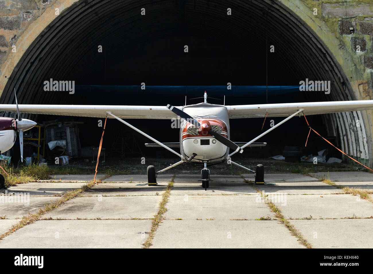 A small two-seater aircraft is in a hangar at the airport Stock Photo ...
