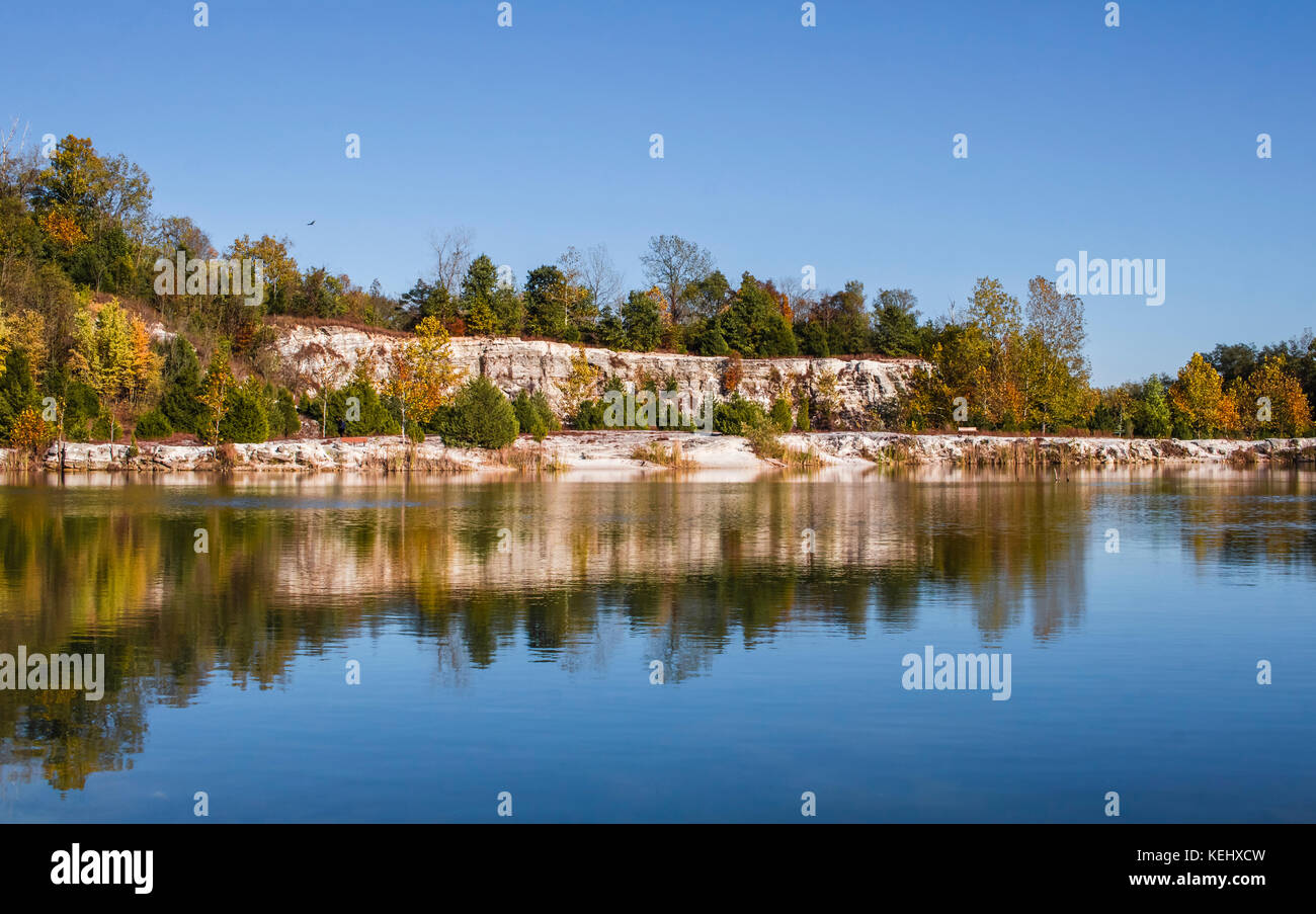 View of a former quarry turned into a park; blue sky above; reflections