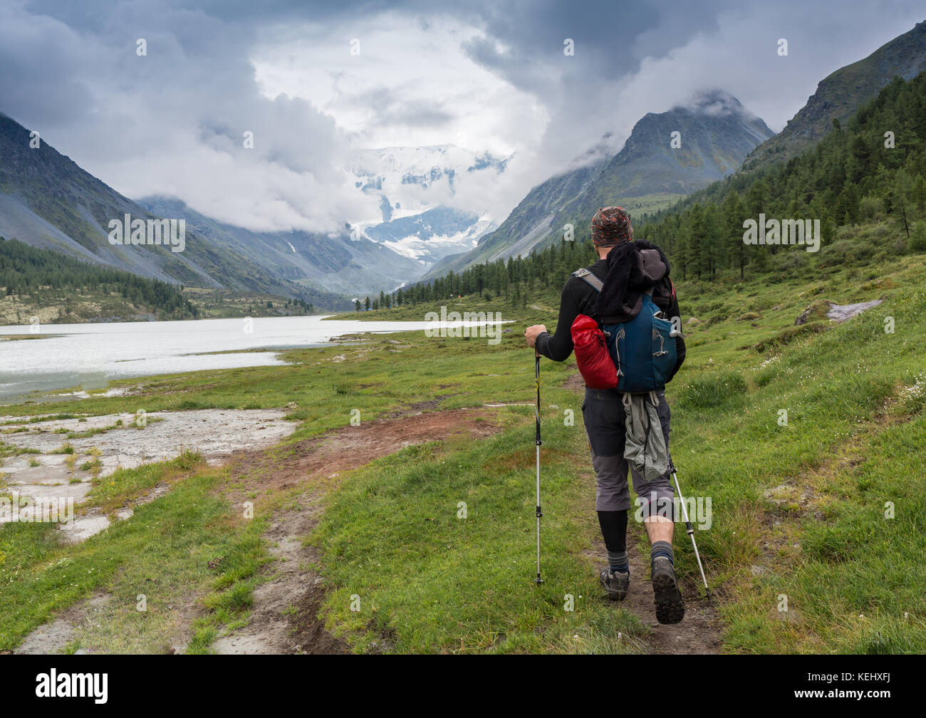 Tourist with a backpack and mountain panorama. Stock Photo