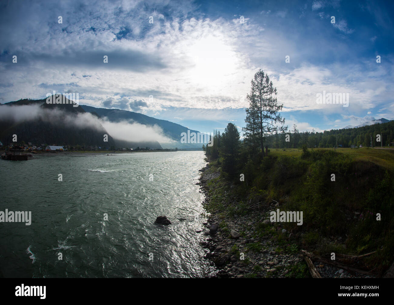 the river on a background of mountains and forests in the fog Akkem river, is at the foot of the Belukha mountain, Altai Mountains, Russia. Stock Photo