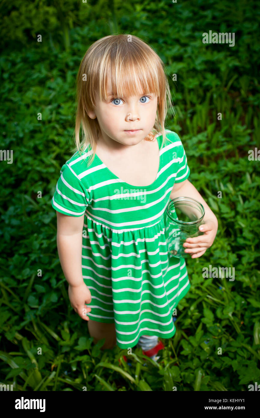 Little girl holding glass jar with snails Stock Photo
